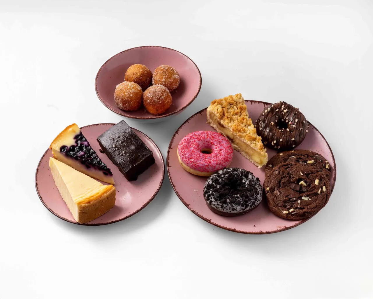 Late Night Box: donuts, a brownie, a cookie and cake on pink plates